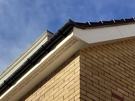 Close-up of the roof verge and fascia on a cream-brick house