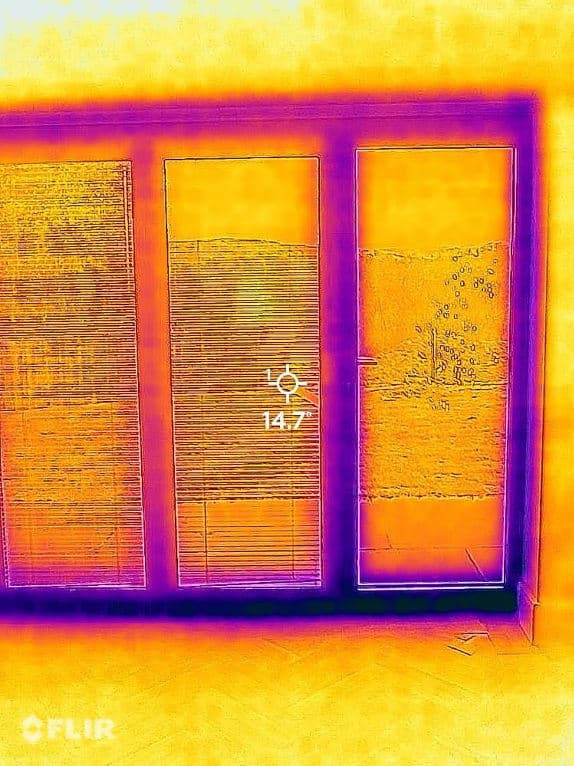 A thermal image of a window showing heat loss around the frame