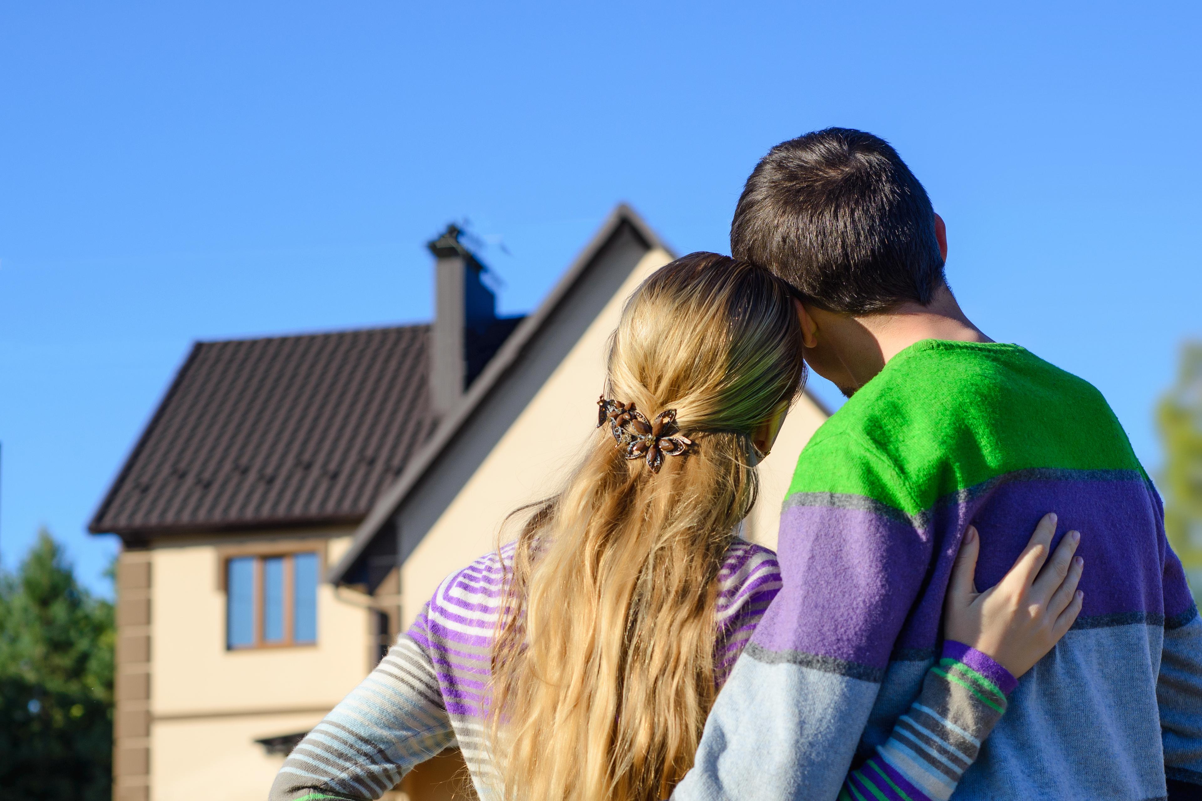 Loving,Couple,Looking,At,Their,Dream,House.,Copy,Space