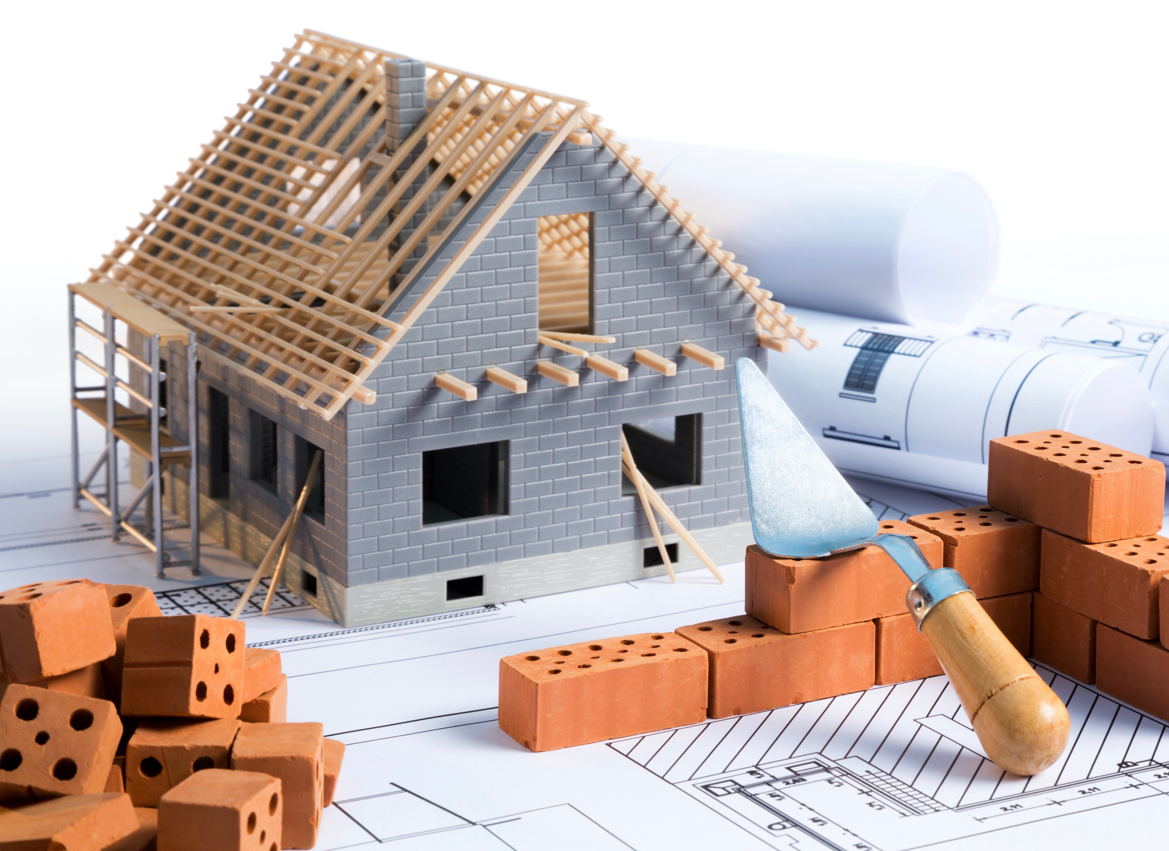 House,In,Construction,-,Project,With,Brick,And,Blueprint