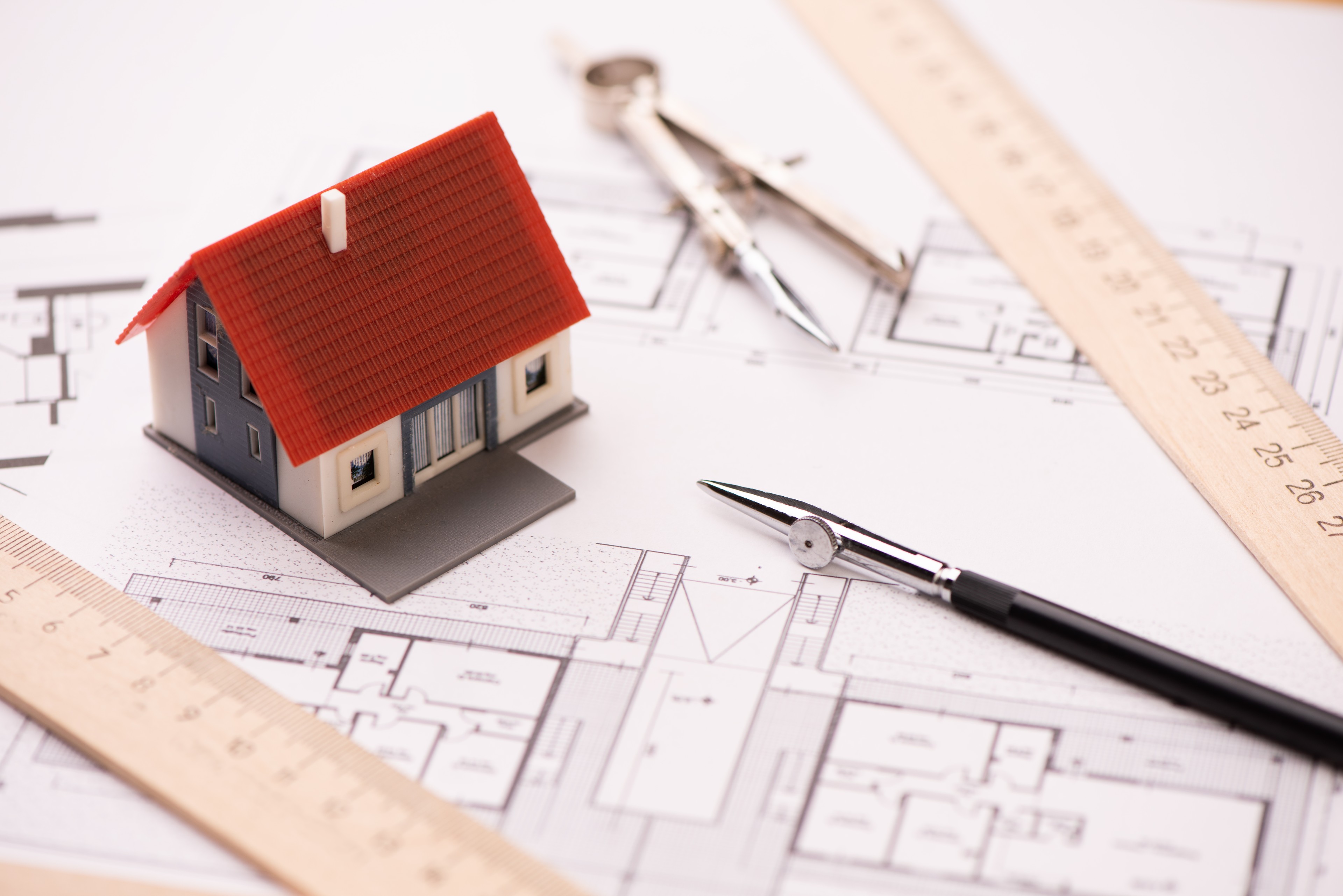 A,Model,House,On,Blueprints,With,Keys,To,The,New